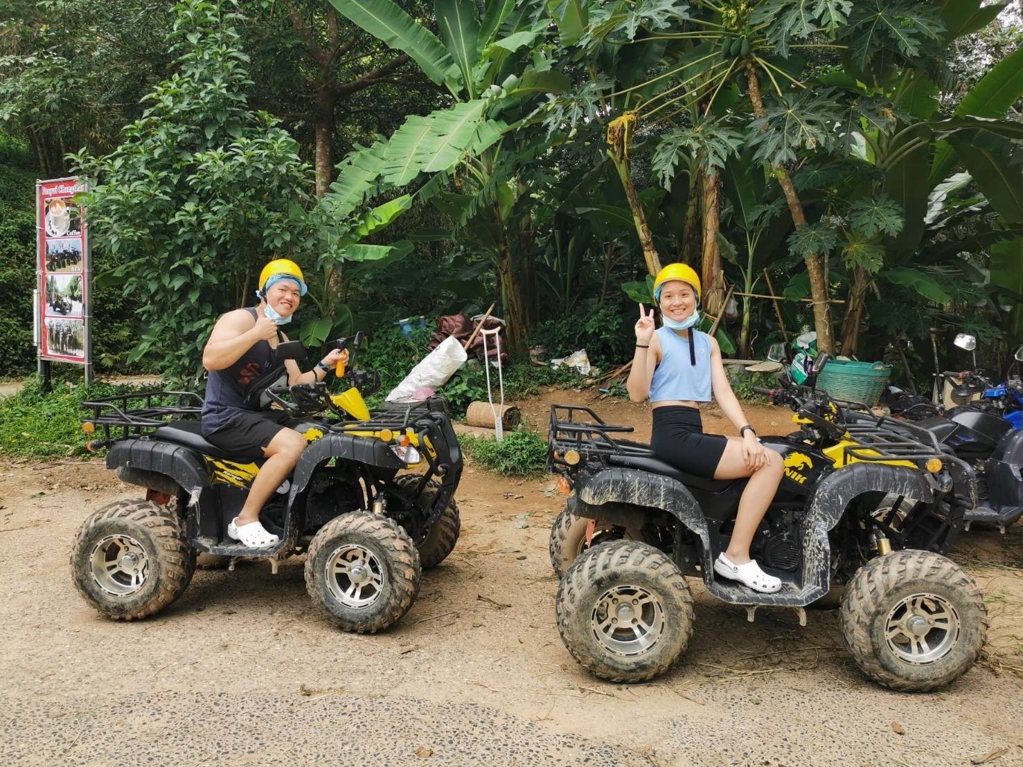 Couple on two yellow ATVs